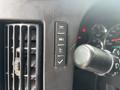 Close-up of the control panel in a 2020 Chevrolet Express featuring various buttons and a gear shift lever