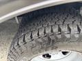 Close-up of a rugged tire mounted on a 2020 Chevrolet Express showcasing deep tread patterns designed for off-road performance