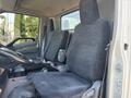 Interior view of a 2018 Hino 195 showing two fabric-covered seats in the cabin with a steering wheel and dashboard visible