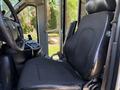 Interior view of a 2013 Chevrolet Express showing the driver's seat with black upholstery and controls on the side