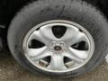 A close-up of a silver alloy wheel from a 2016 Subaru Forester featuring five spokes and a central lug nut with visible wear and staining on the tire