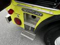 A close-up of a 1995 Freightliner FL086 featuring a metal step with diamond plating and a prominent Freightliner logo on the side