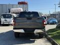 A 2018 Ford F-150 viewed from the rear with a gray exterior and chrome accents on the bumper and tailgate