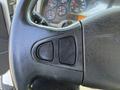 Close-up of the steering wheel of a 2008 International 7500 featuring black leather and two control buttons on the left side of the wheel