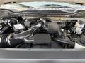 The engine compartment of a 2020 Ford F-350 SD showing the engine components and various mechanical parts