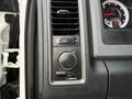 Dashboard controls of a 2013 RAM 3500 featuring knobs and buttons for lights and air conditioning