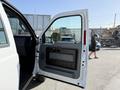A 2015 Ford F-550 with the driver's side door open showing the interior door panel and handle