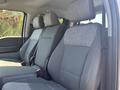 Interior view of a 2023 Ford F-350 SD featuring two front seats with gray fabric upholstery and headrests