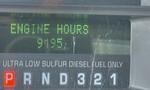 Display screen of a 2009 Ford F-550 showing engine hours at 9195 with indicators for gear selection and fuel type