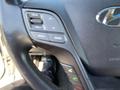 The steering wheel controls of a 2018 Hyundai Santa Fe featuring buttons for volume mute and mode settings