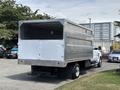 A 2020 Chevrolet Silverado with a metallic, box-style bed and a white rear door positioned on a parking lot