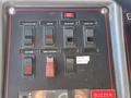 Close-up of a control panel featuring various switches and buttons for a 1992 Emergency One Typhoon Superior fire truck including ignition and engine controls