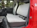 Interior view of a 2001 Toyota Dyna showing two gray patterned seats with a central gear lever in the cab