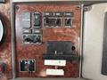 Control panel of a 2008 Kenworth T370 featuring buttons for start stop engine brake and various controls with a slot for a key or card reader