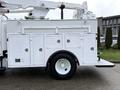 2005 Freightliner M2 106 with a white utility body featuring multiple compartments and a boom lift mounted on top