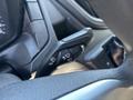 A close-up of a 2016 Ford Transit 150's control stalk for windshield wipers and headlights showing various function icons