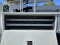 White truck storage compartment with multiple horizontal shelves inside