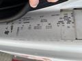 A 2012 International 7300 Workstar vehicle identification label displaying details such as axle, tire specifications, rim size, and recommended tire pressure