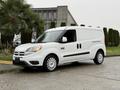 White 2017 RAM ProMaster City van parked on a wet surface featuring a black front grille and silver wheels