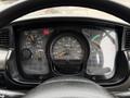 Dashboard of a 2009 UD Trucks UD 3300 displaying speedometer and gauges for air pressure and fuel levels with a black steering wheel in the foreground