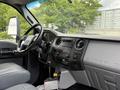 Interior of a 2017 Ford F-750 featuring a black steering wheel leather seats and a central dashboard with audio controls and ventilation system