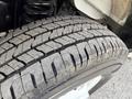A close-up view of a 2023 Ford E-450 tire showing detailed tread pattern and rubber texture