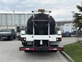 A 2016 Peterbilt 348 truck with a large cylindrical tank mounted on its flatbed and equipped with a safety light on top