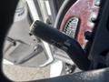 Close-up of a turn signal lever in a 2022 Freightliner M2 106 showing symbols for off push and pull flash