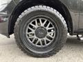 A black wheel with a multi-spoke design and a robust tire mounted on a 2018 RAM 1500