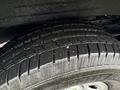 Close-up of the tread of a tire from a 2023 GMC Savana showing a deep pattern for traction and stability