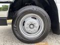A close-up view of a Kumho tire mounted on a 2014 Ford E-350 van featuring a standard steel rim and visible tread pattern