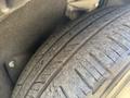 Close-up of the tread on a tire from a 2023 Fisker Ocean showing detailed grooves and wear patterns