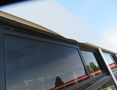 A 2020 Chevrolet Express van with tinted windows and a white roofline