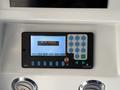 A control panel with buttons and a digital display showing the message OUT OF SERVICE on a 2016 Grande West Vicinity bus
