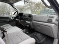 Interior of a 2006 Ford F-450 SD showing the dashboard steering wheel and front seats with a focus on the gear shift and control panel