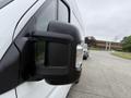 Close-up of the side mirror of a 2020 RAM Promaster showcasing its black casing and integrated turn signal light