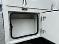 A storage compartment with a black rubber seal and silver latch on a 2013 Ford F-250 SD truck