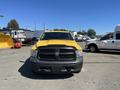 Front view of a yellow 2015 RAM 1500 pickup truck with a black grille and no visible license plate