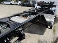 Close-up of a 2022 Lion Lion6 electric truck chassis showing the exposed frame and battery components with visible wiring and structural elements