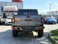 A rear view of a 2021 Jeep Gladiator showcasing its tailgate with the Jeep logo and distinctive taillights