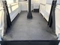 A 2006 Freightliner M2 106 with a flat loading area featuring diamond plate flooring and sturdy side rails for security
