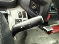Close-up of the steering column controls in a 2015 Hino 195 featuring various switches including wiper control headlights and indicator levers