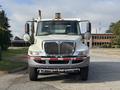A 2012 International DuraStar 4300 truck is shown head-on with a distinctive grill and headlights visible along with side mirrors and a roof-mounted light bar
