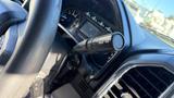 Close-up of the steering wheel and gear shift of a 2016 Ford F-150 with a focus on the gear shift lever and dashboard indicators