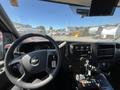 Interior view of a 2013 Chevrolet Express with a steering wheel dashboard controls and gear shifter displayed prominently in the foreground
