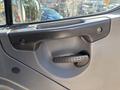 Close-up of the interior door handle of a 2006 Freightliner M2 106 featuring a textured grip and metallic frame