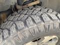 A rugged tire with deep treads mounted on a 2014 Ford F-150 showcasing its durability and off-road capability