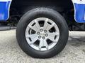 A close-up view of a silver alloy wheel on a 2017 Chevrolet Colorado featuring a black tire with the brand name Terra Trac AT visible on the sidewall