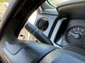A close-up view of the turn signal and windshield wiper control stalk on the steering column of a 2014 Ford F-150