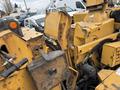 A yellow 2015 Vermeer Corporation BC1200XL wood chipper showing metal components and hoses with a worn exterior